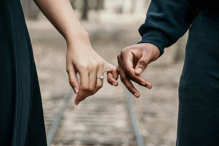 Two people holding hands